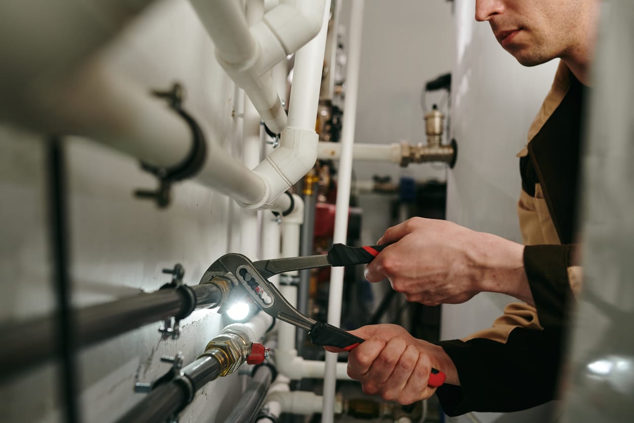 Plumbers maintaining commercial plumbing pipes in Auburndale