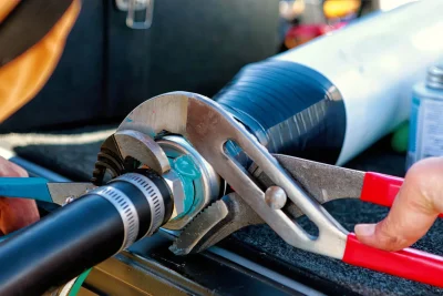 Technician tightening an industrial pipe connection in Auburndale