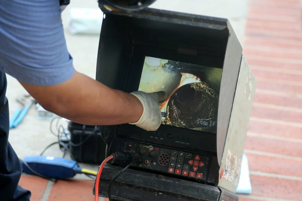 Technician viewing a drain inspection camera in Auburndale
