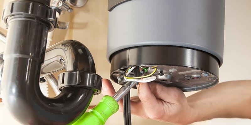 Technician repairing the heating element of a water heater in Auburndale