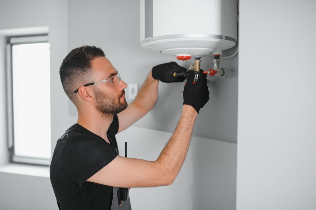 Technician performing water heater maintenance in Auburndale